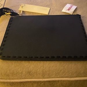 Black faux leather purse with suede tassel. Brand new